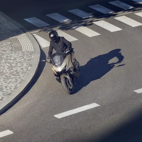 Figurant predvádzajúci motocykel Forza 750 na ulici.