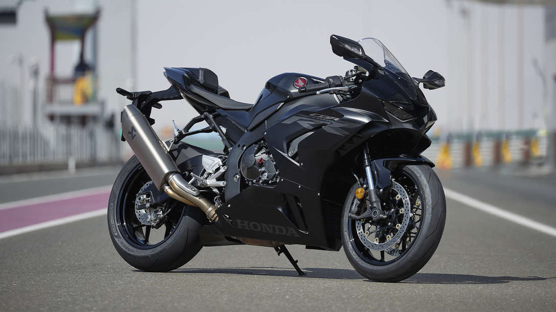 Honda CBR1000RR-R Fireblade, trojštvrťový záber spredu z pravej strany, čierny motocykel zaparkovaný na pretekárskej dráhe