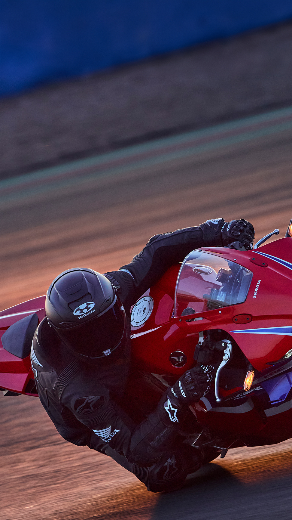 CBR600RR on track with rider in corner.