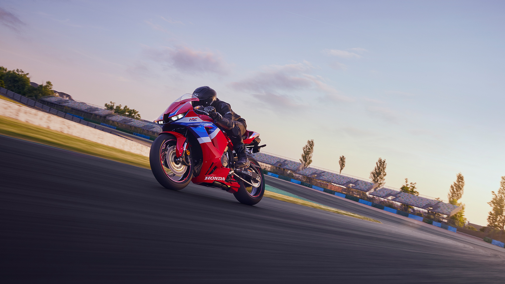 Dynamický trojštvrťový zadný záber na model CBR600RR pri jazde na okruhu.